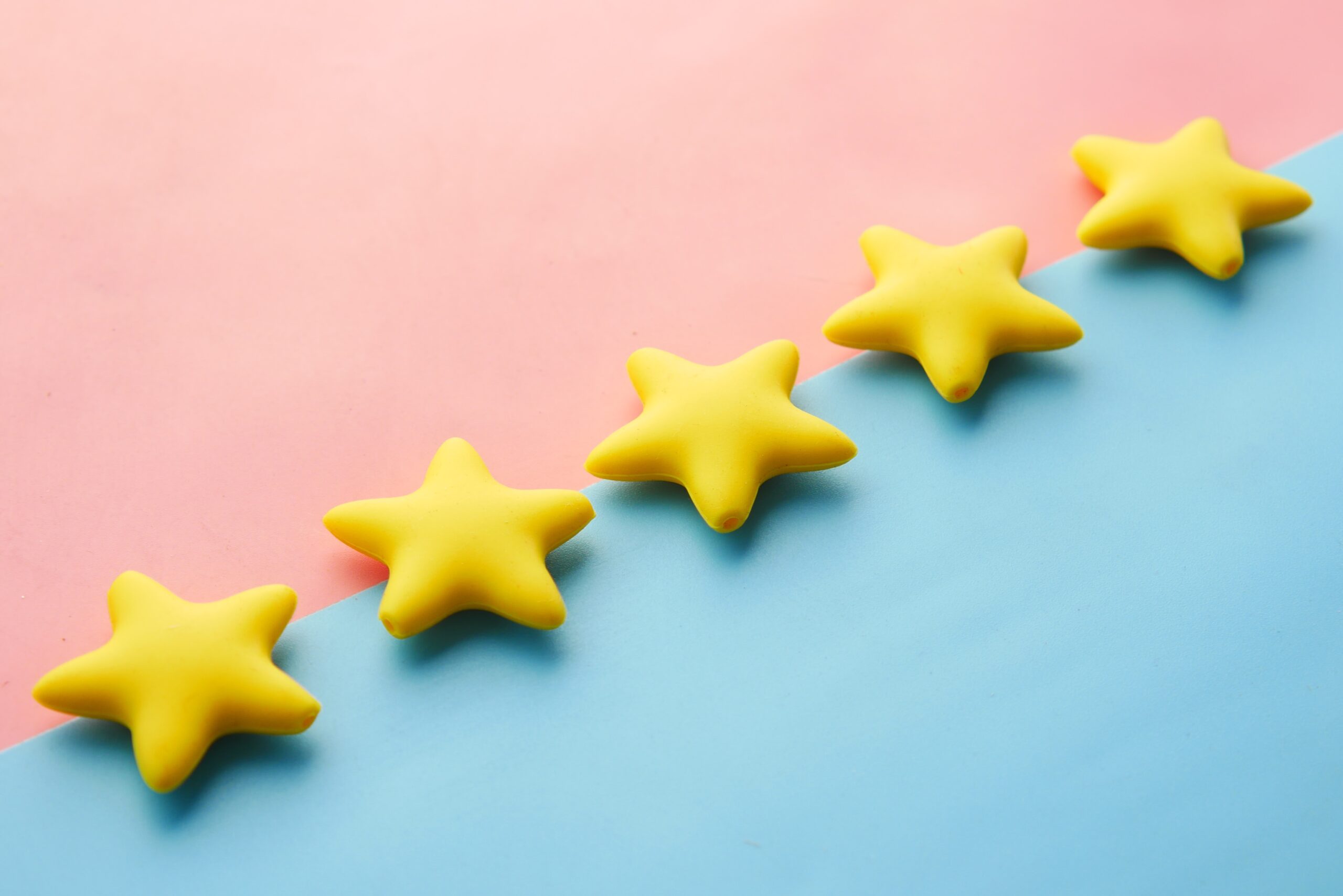 Five yellow stars on a blue and pink surface.