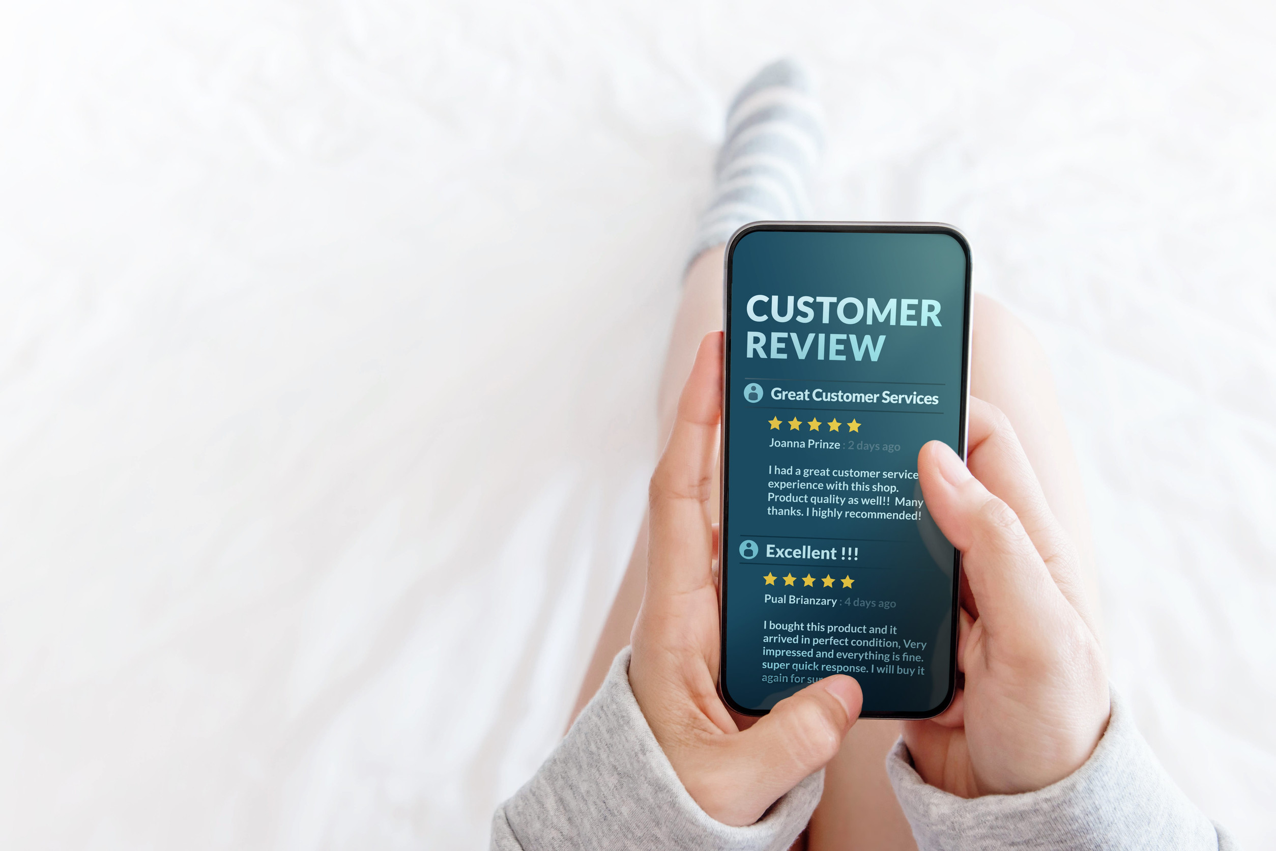 Customer viewing five star reviews on a business's phone screen